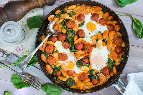 Butter beans, chorizo and spinach baked eggs