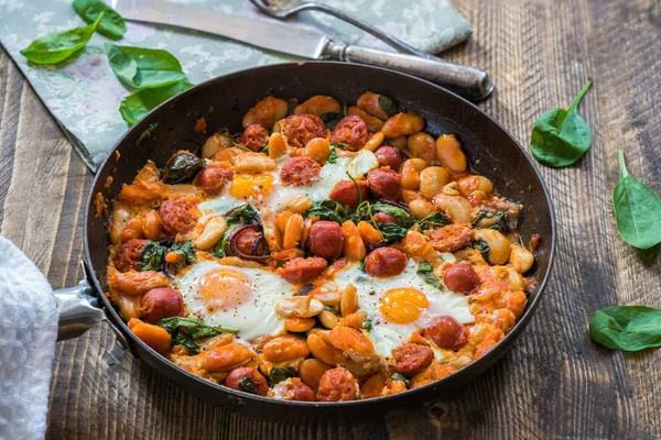 Butter beans, chorizo and spinach baked eggs