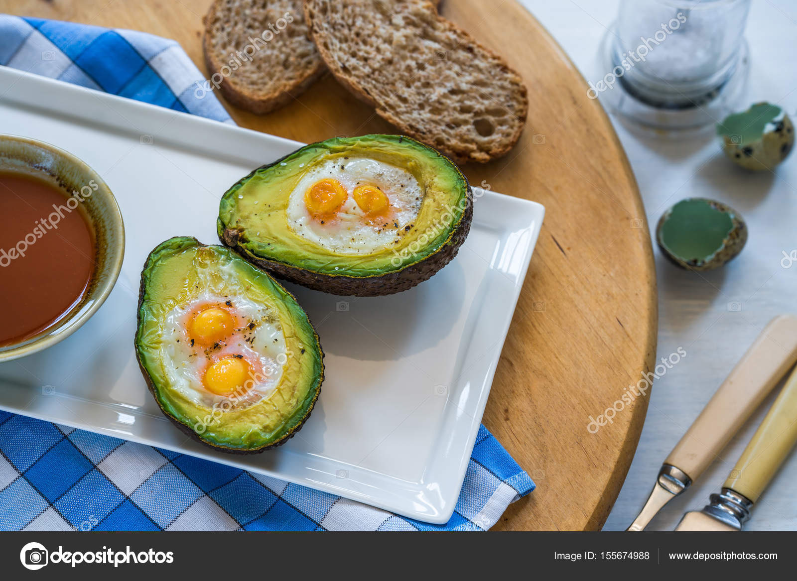 Baked avocado with quail eggs Stock Photo by ©RubinowaDama 155674988
