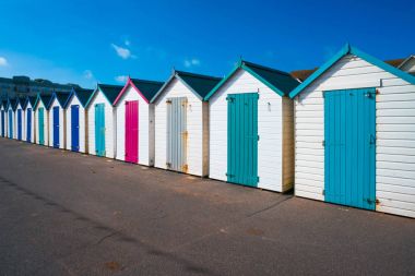 Colorful wooden huts on the beach clipart
