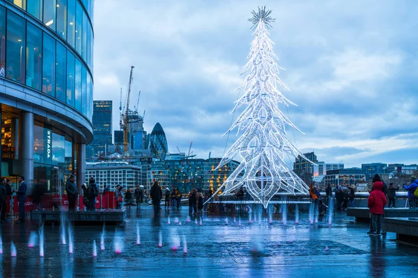 View of a  modern glass Christmas tree standing next to the City — Stock Photo, Image