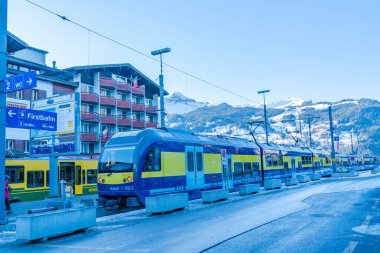 GRINDELWALD, SWITZERLAND - JANUARY 16 2020: Grindelwald train station with passanger waiting to board a train. The station is the terminus for trains going to both, Interlaken Ost and Kleine Scheidegg
