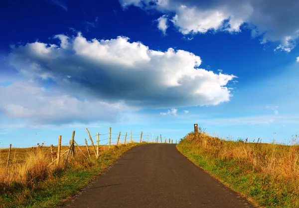 Landscape with road field and big clouds. — Stock Photo, Image