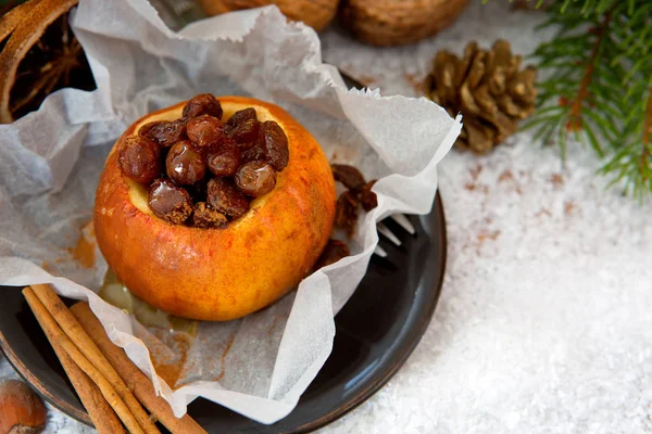 Baked apple with raisins and christmas decoration. — Stock Photo, Image