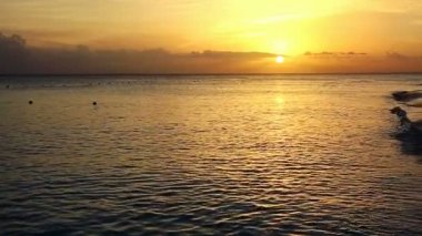 Denizin üzerinde altın gün doğumu günbatımı.