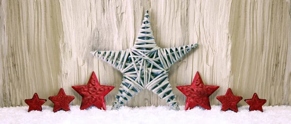 Red Christmas stars and snow. — Stock Photo, Image
