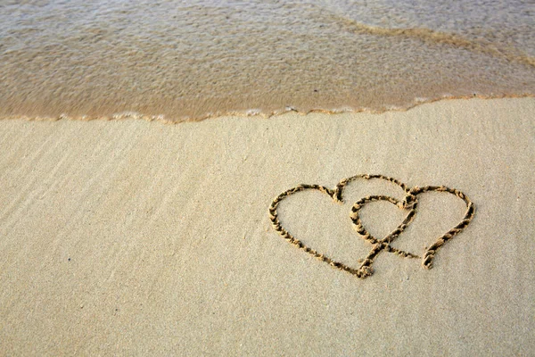 Zwei Liebesherzen am karibischen Strand. — Stockfoto