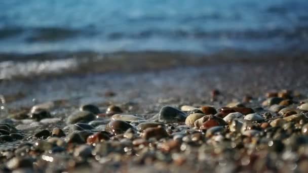 Waves washing over gravel beach. — Stock Video