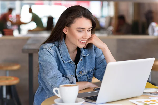 Glad freelancer undersöker hennes laptop — Stockfoto