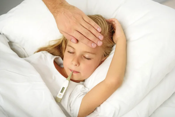 Mano de los padres revisando a su hija por fiebre — Foto de Stock