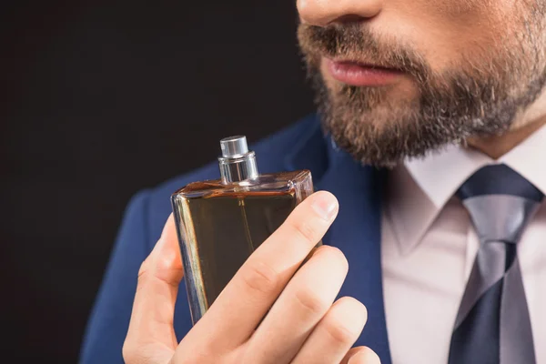 Successful businessman likes perfume scent — Stock Photo, Image