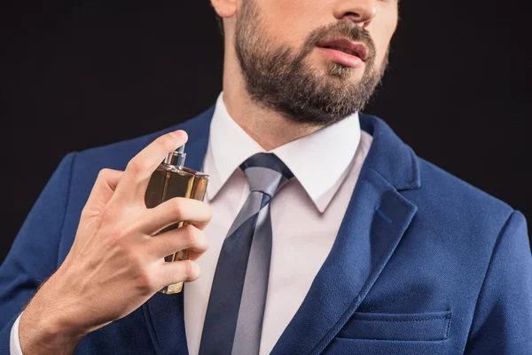 Attractive businessman wearing scent with pleasure — Stock Photo, Image