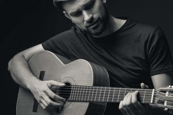 Skillful male guitarist enjoying his music