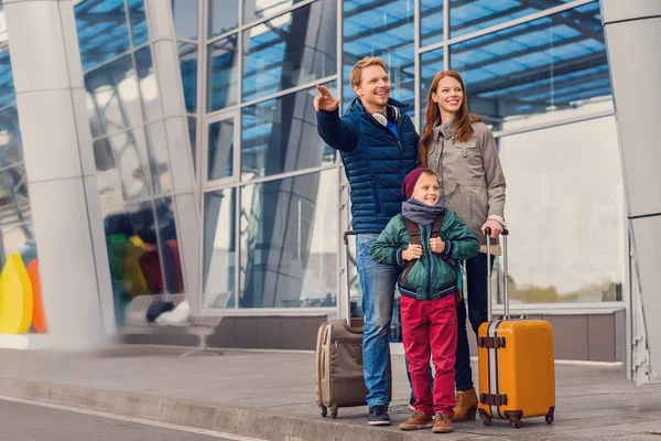 Lachende gezin met kind op luchthaven — Stockfoto