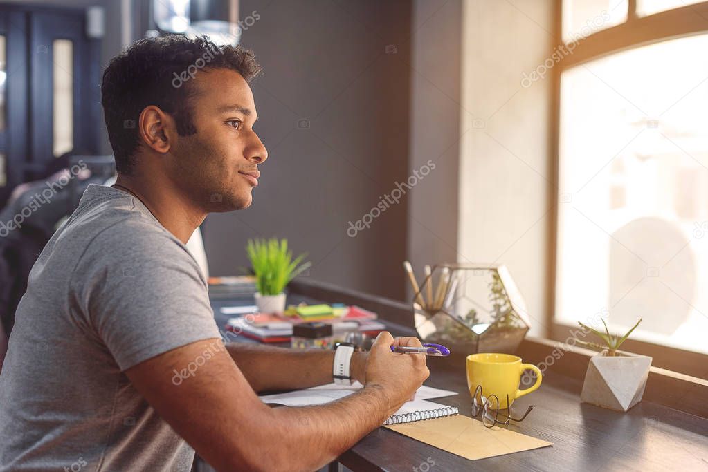 African man studying in cafe