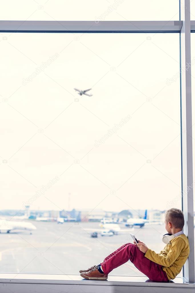 Little boy sitting at airport