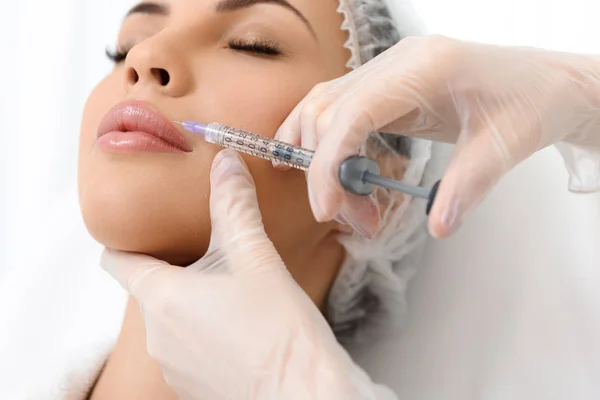 Skillful doctor injecting lips with hyaluronic liquid — Stock Photo, Image