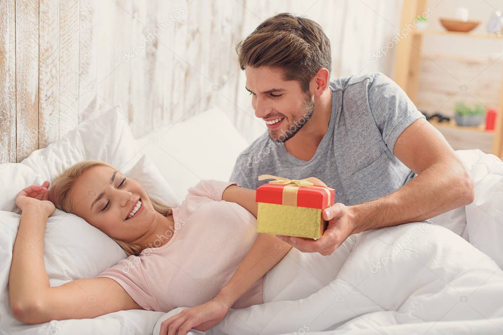 Happy man giving present to his wife
