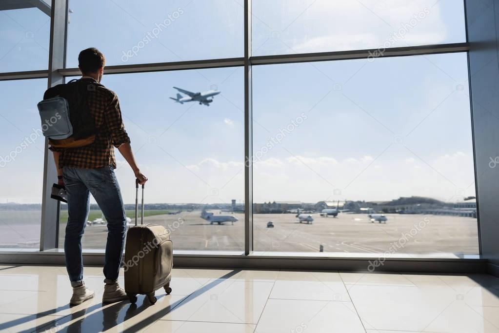 Male tourist looking at flight