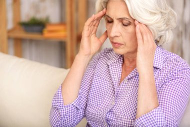 Yaşlı kadın korkunç baş ağrısı vardır