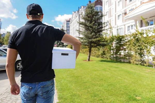 Man standing with a cardboard box — Stock Photo, Image