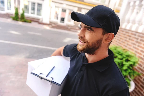 Close up of smiling courier in a cap — Stock Photo, Image