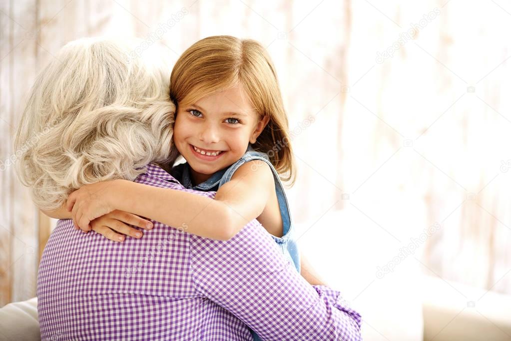 Pretty child hugging her grandmother