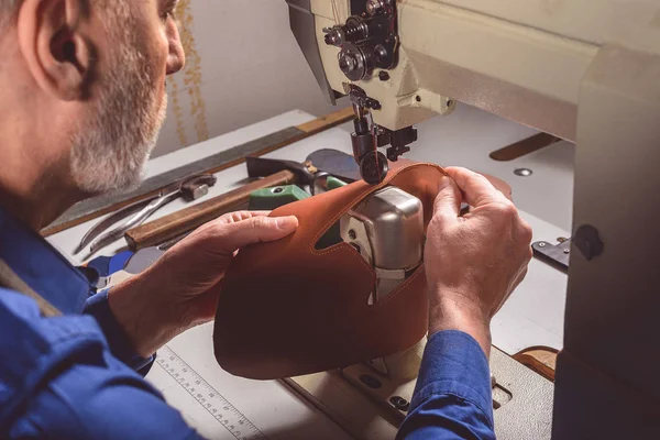 Craftsman stitching a leather part of the shoe — Stock Photo, Image
