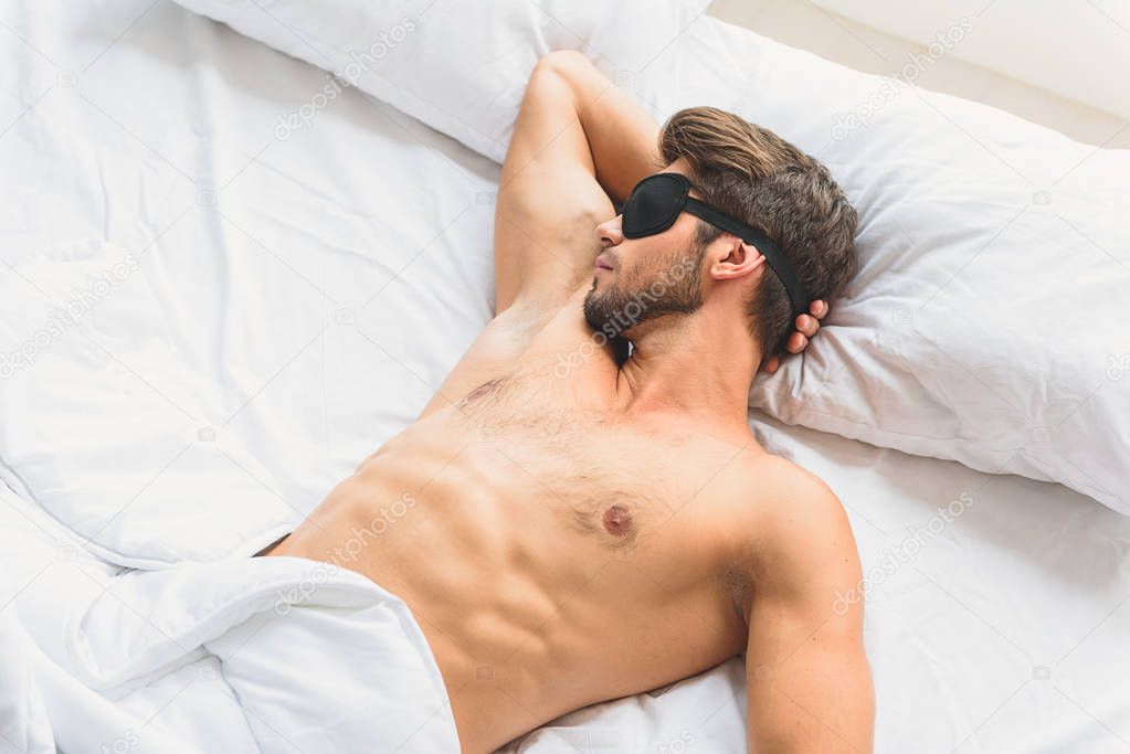 Calm guy enjoying dream in bedroom