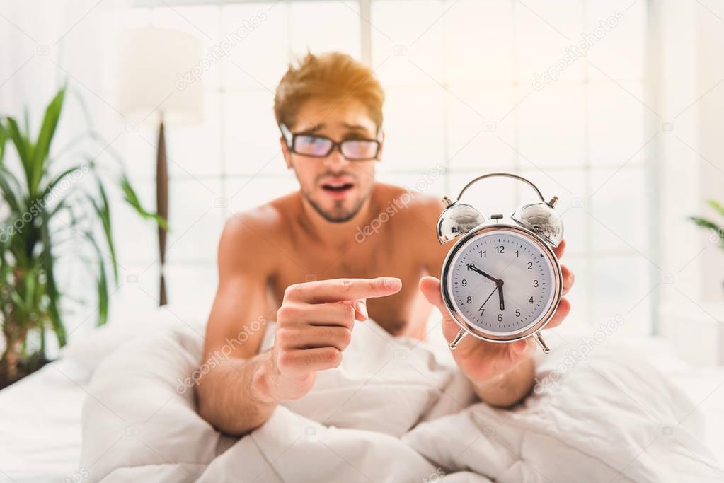 Sad guy does not want to get up from bed