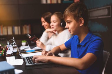 Onun laptopunda yazmaya konsantre çocuk