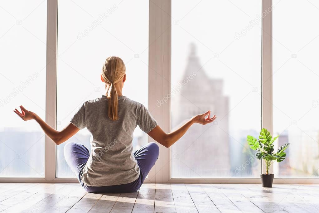 Healthy girl meditating with serenity