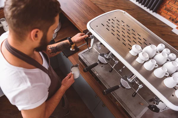 Bearded barista working in front of the coffee machine — Stock Photo, Image