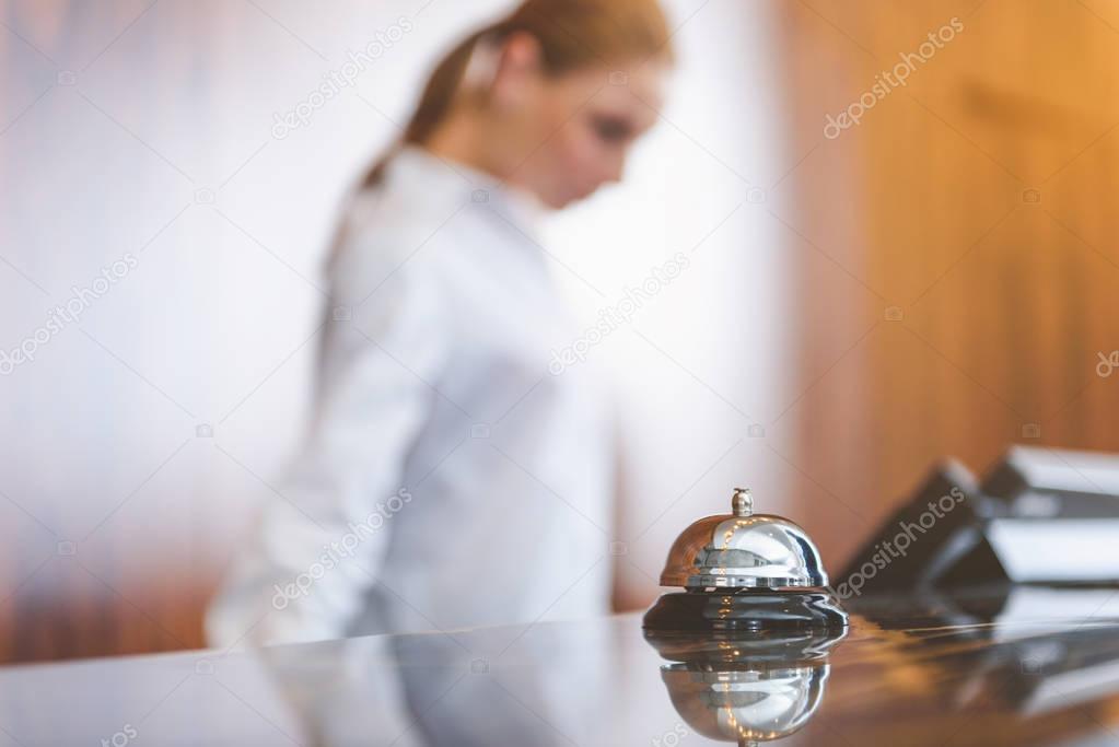 Woman working behind reception desk