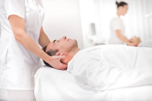 Male client enjoying facial treatment at spa — Stock Photo, Image