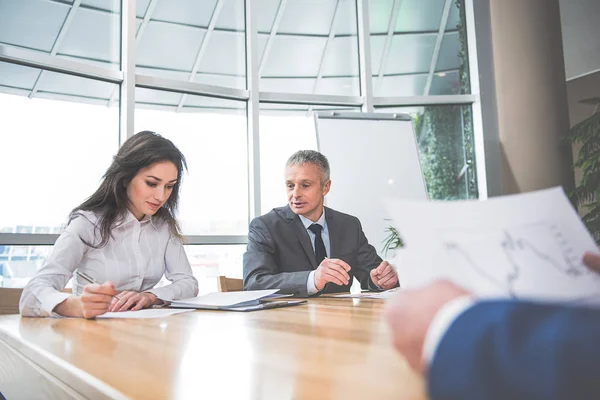 Serious people sitting at the office — Stock Photo, Image