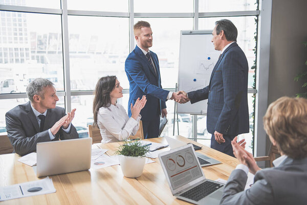 Two men are shaking hands