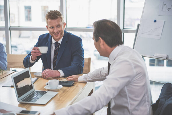 Two men are smiling at work