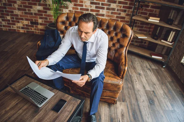 Businessman attentively looking through documents — Stock Photo, Image