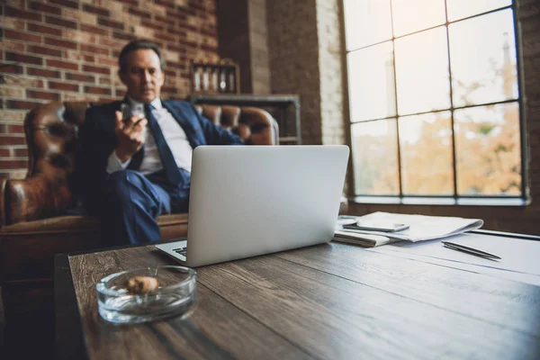 Serious middle aged male businessperson relaxing — Stock Photo, Image