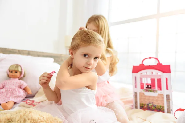 Beautiful female kids smartening in bedroom — Stock Photo, Image