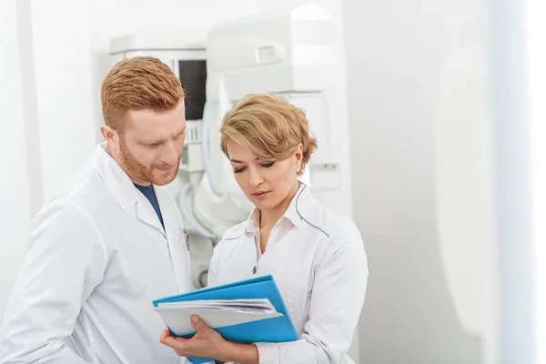 Serious doctors hardly working in clinic — Stock Photo, Image