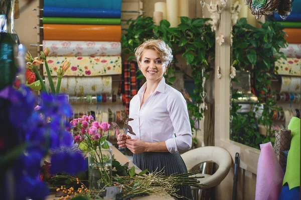 Skillful female florist working with flowers — Stock Photo, Image