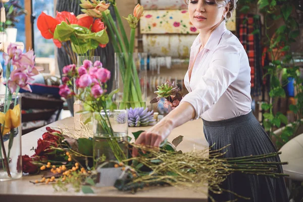Talented woman making masterpiece from flowers — Stock Photo, Image