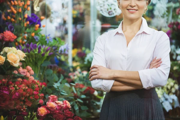 Happy female florist posing near flowers — Stock Photo, Image
