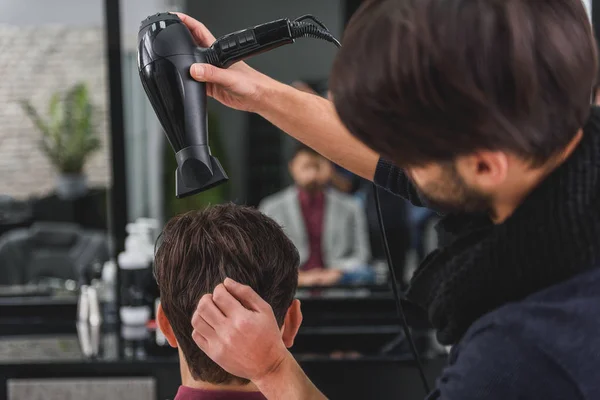 Professional hairdresser making human head dry — Stock Photo, Image