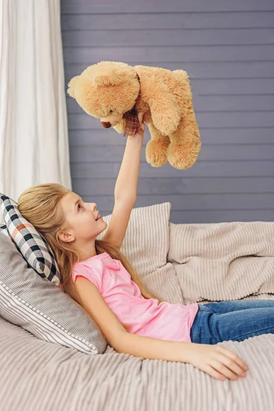 Stock image Cheerful kid having fun with soft toy