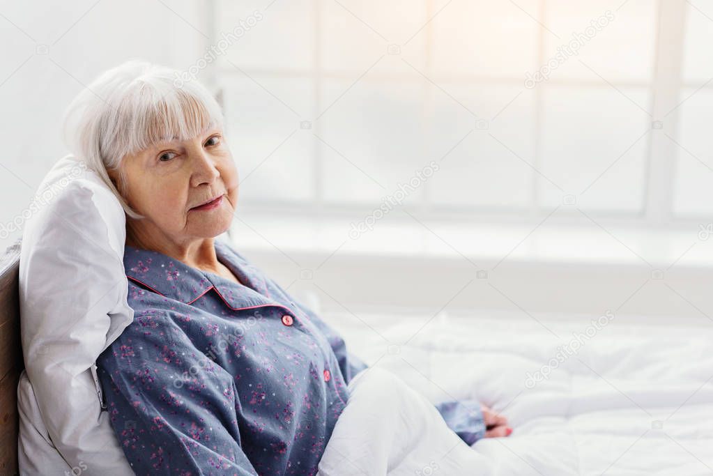 Serene grandmother resting in hospital office