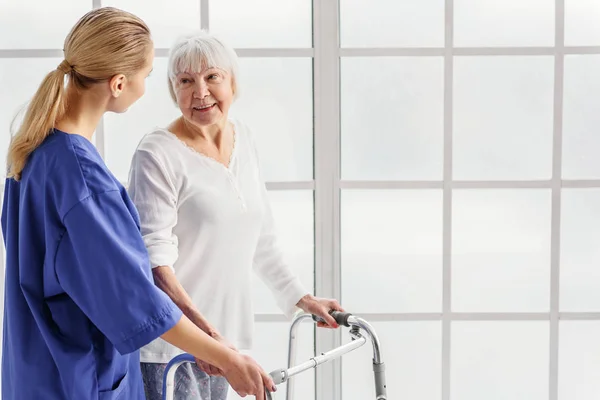 Arzt versorgt Rentner mit Dachrinnengestell — Stockfoto