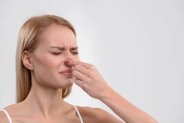 Young woman feeling disgust about scent — Stock Photo, Image